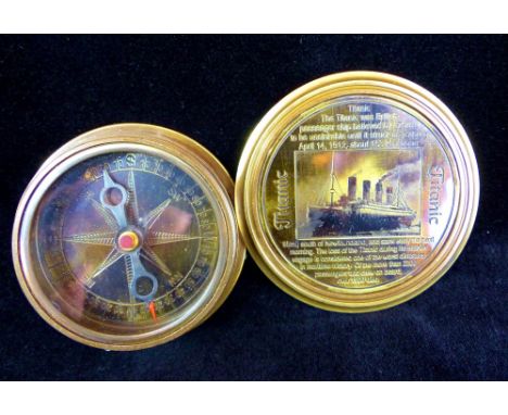 Handheld brass compass depicting a picture ot the Titanic to lid