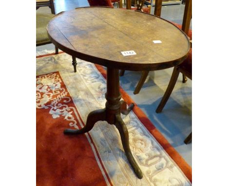 Oak oval tip top table with tripod base.