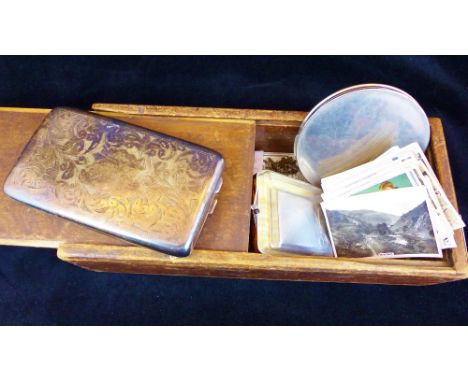 Vintage wooden box with mixed contents including photographs.