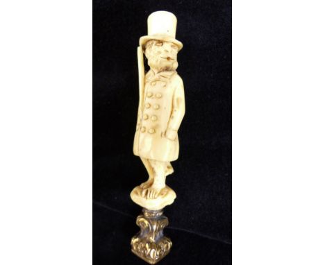 Carved ivory seal in form of a Monkey in 19thC clothing with yellow metal seal. H: 7 cm