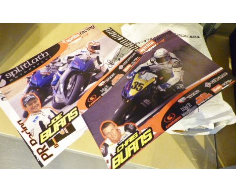 Shelf of vintage motorcycle racing posters, some signed