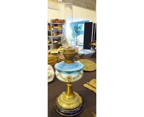 Victorian oil lamp, ceramic base brass stem leading to blue and white opalescent glass reservoir and funnel. H: 63 cm