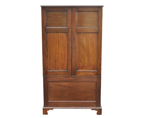 A George III and later small mahogany wardrobe, the twin panel doors above a panelled base section, H 156cm, W 85cm, D 47cm
