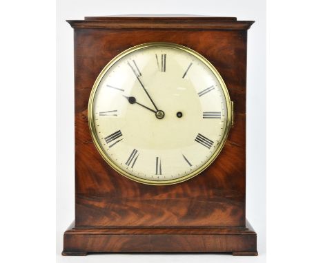A Regency mahogany bracket clock, C.1820,  the shaped pediment over an eight inch painted tin dial, enclosing a single train 