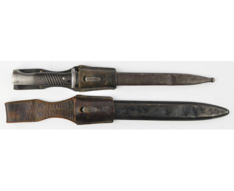 A German K98 Mauser Bayonet. The forte marked 43 FNJ, the blade 24.6cm, metal scabbard with leather frog, together with anoth