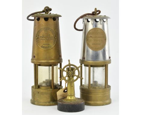 An Eccles Type 6 miners safety lamp by the Protector Lamp and Lighting Co. Ltd,  a Type 1A safety lamp and a brass ships whee