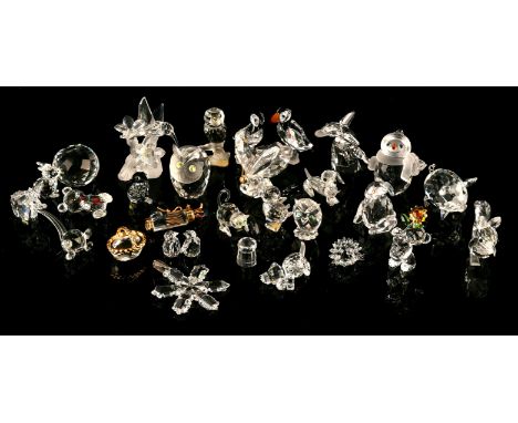 Approximately twenty six Swarovski crystal animals and other items, to comprise a snow man, a pair of puffins, a pig, a Chris