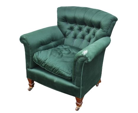 An Edwardian mahogany and upholstered tub form armchair, the curved buttoned back with loose cushion, on short tapered legs w
