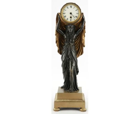 An Egyptian Revival bronze clock, 19th Century, modelled as an Egyptian woman wearing a long shift dress, standing on a stepp