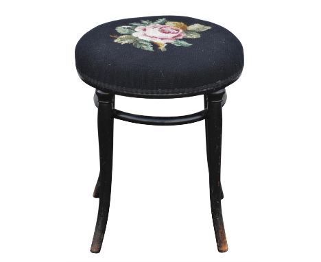 A Thonet ebonised bentwood stool, with a rosehead tapestry seat, on splayed legs, underside with label for 'Thonet Wien', H 5
