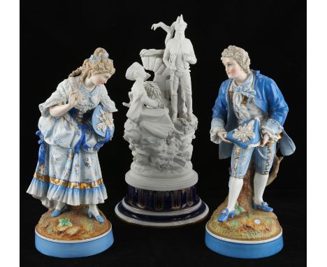A pair of early 20th century porcelain figures, modelled as gallant and companion, each wearing blue tones and raised on a ci
