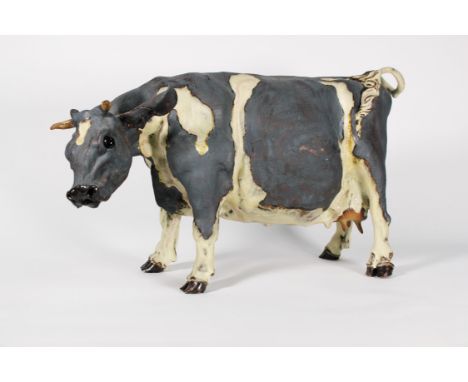 Elaine Peto (British 20/21st Century), a sculpture of a spotted cow, Ceramic, Height 28cm, Length 50cm, Width 18cm. Purchased