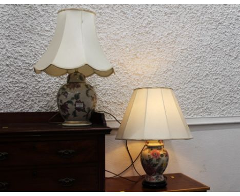 Two floral ceramic lamp bases formed as ginger jars, with shades  