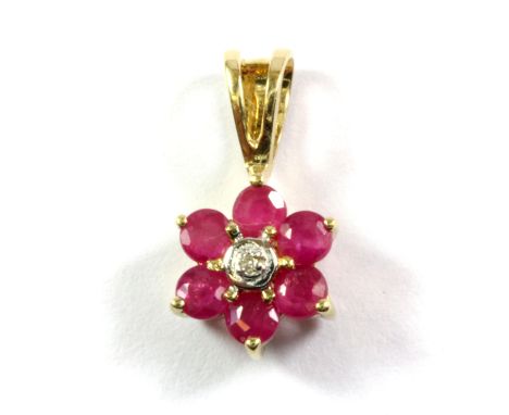 A 9ct yellow gold ruby and diamond set flower shaped pendant, L. 1.5cm.