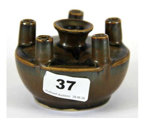 A small brown glazed Chinese porcelain oil lamp, H. 6.5cm.