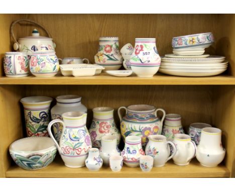 A large collection of Poole pottery.