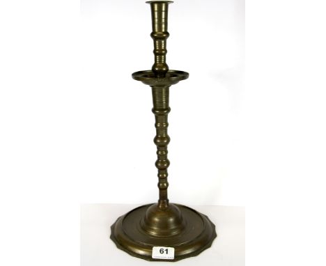An 18th Century brass candlestick, H. 42cm.