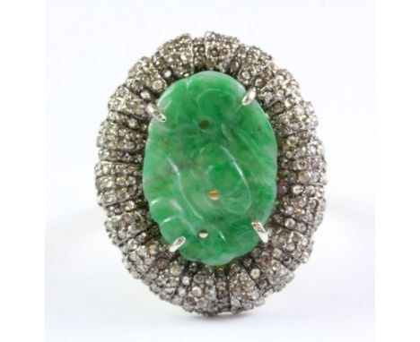 A yellow and white metal cluster ring set with a carved jade and diamonds, (M.5).