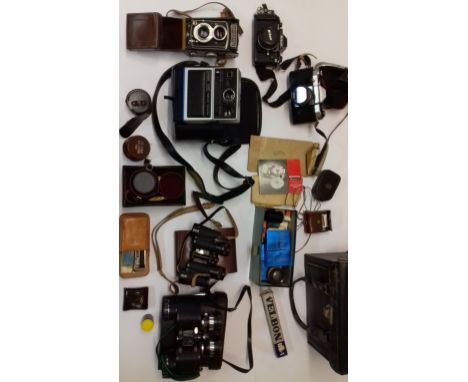 A tin trunk containing a quantity of mixed cameras including a Rolleicord.
