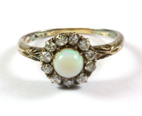 A yellow metal opal and diamond set cluster ring, (P.5).