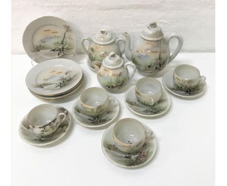 JAPANESE EGGSHELL CHINA TEASETall with mountain and landscape decoration, comprising teapot, two handled sugar bowl, milk jug