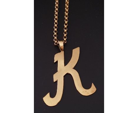 NINE CARAT GOLD 'K' PENDANTon nine carat gold belcher link chain, the chain 43cm long, total weight approximately 12.8 grams 