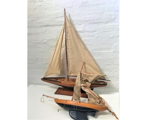 20th CENTURY MAHOGANY MODEL YACHTwith a painted dark blue hull, full rigging and mounted on a stand, 94cm long, together with