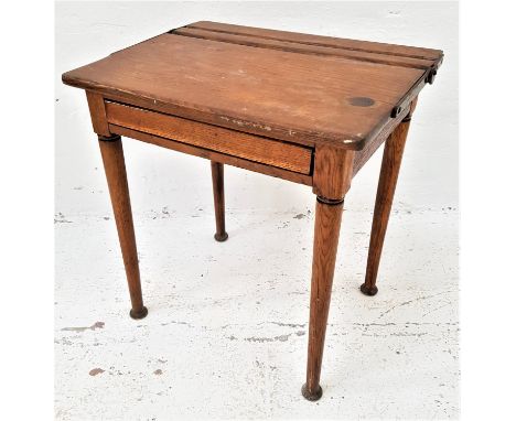 VINTAGE ELM CHILD'S SCHOOL DESKwith a pen trough and lift up lid above a front flap, standing on tapering supports with pad f