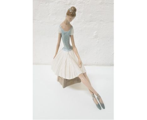 LARGE NAO FIGURINEof a seated ballerina, 33m high 
