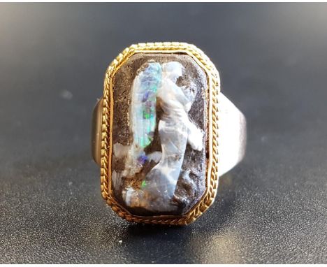 UNUSUAL BOULDER OPAL CARVED CAMEO DRESS RINGthe cameo depicting the winged Nike with a serpent at her feet, on unmarked gold 