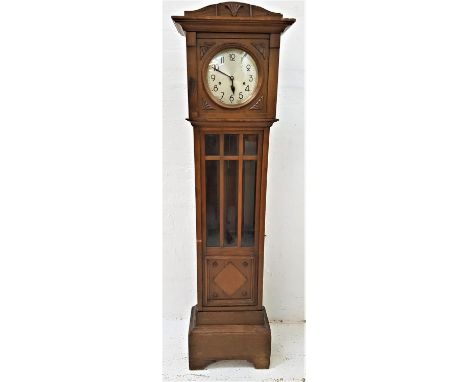 OAK LONGCASE CLOCKthe circular silvered dial with Arabic numerals and Westminster chime movement, above a panelled glass door