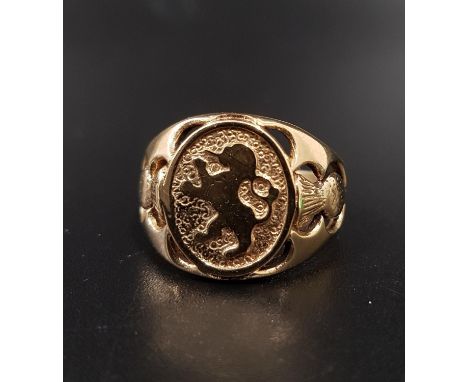 UNUSUAL UNMARKED GOLD DRESS RINGthe central oval panel depicting a lion rampant, with pierced thistle decoration to each shou