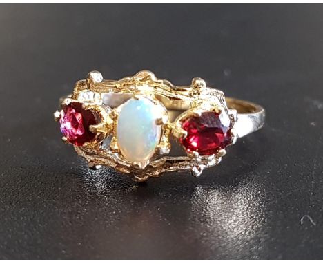 OPAL AND GARNET THREE STONE RINGthe central oval cabochin opal flanked by oval cut garnets, in pierced and shaped setting, on