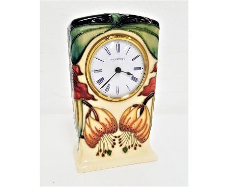 MOORCROFT 'ANNA LILY' PATTERN MANTEL CLOCKthe tube lined floral decoration on a cream ground, 16cm high 