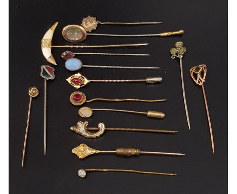 SELECTION OF GOLD AND OTHER STICK PINSincluding a double fox tooth example with gold mounts; a ten carat gold example set wit