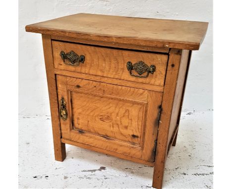 LIGHT OAK BEDSIDE CUPBOARDwith a moulded top above a frieze drawer and a panelled cupboard door below, 51cm high 