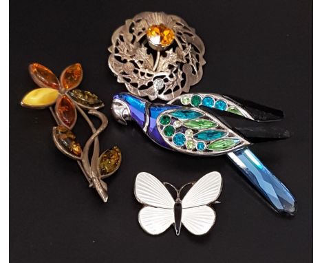 FOUR SILVER BROOCHEScomprising a Norwegian white enamel decorated butterfly, 2.8cm wide; a Scottish thistle decorated brooch;