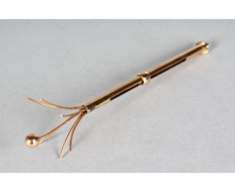 A 9CT GOLD SWIZZLE STICK.