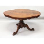 A VICTORIAN FIGURED MAHOGANY SHAPED TOP TABLE, on centre pillar ending in three curving legs. 4ft