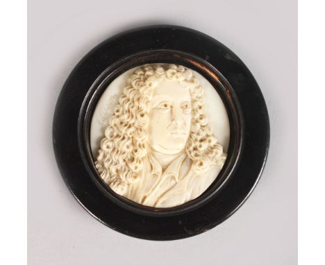 A EUROPEAN CARVED IVORY PLAQUE. Signed Addisson.  2ins diameter, in a wooden frame.