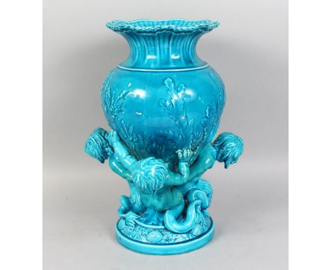 A GOOD LARGE MINTON BLUE GLAZE VASE, held by two cupids on a base with shells. 17ins high.