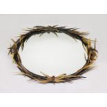 A LARGE ANTLER OVAL MIRROR, the frame entwined with antlers of various sizes. 4ft 6ins high x 3ft