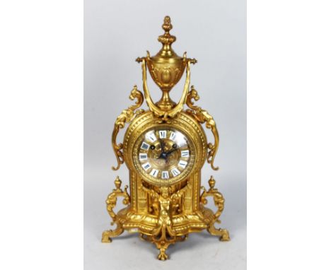 A 19TH CENTURY FRENCH BRASS MANTLE CLOCK, with eight-day movement, black and white Roman numerals, (bell missing), with urn f