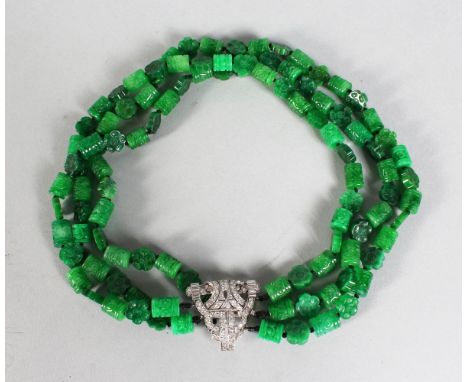 A THREE ROW JADE NECKLACE with ART DECO DIAMOND CLASP.