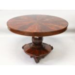 A LATE REGENCY ROSEWOOD CIRCULAR SEGMENTED TOP DINING TABLE, on a centre column with circular base