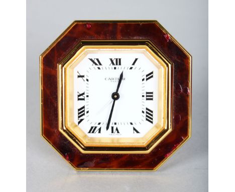 A CARTIER RED ENAMEL OCTAGONAL CLOCK in a red velvet Cartier bag.