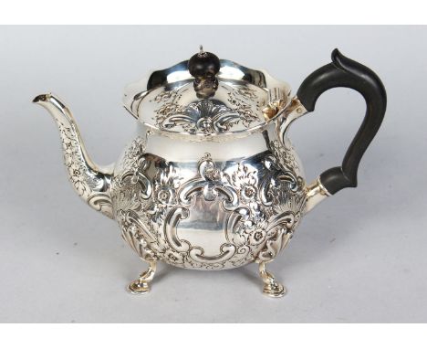 A TEAPOT with repousse decoration, ebony handle and finial. London 1901.  Maker's: The Barnards.