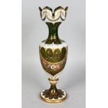 A BOHEMIAN TALL SLENDER WHITE OVERLAY, RUBY AND GILT VASE painted with garlands of flowers. 13ins