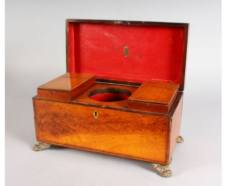 A GEORGE III SATINWOOD TWO-DIVISION TEA CADDY, with two lidded tea boxes, rising lid and supported on brass claw feet. 12ins 