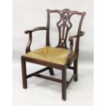 A 19TH CENTURY CHIPPENDALE STYLE MAHOGANY ARMCHAIR, with pierced vase splat, curving arms, drop-in